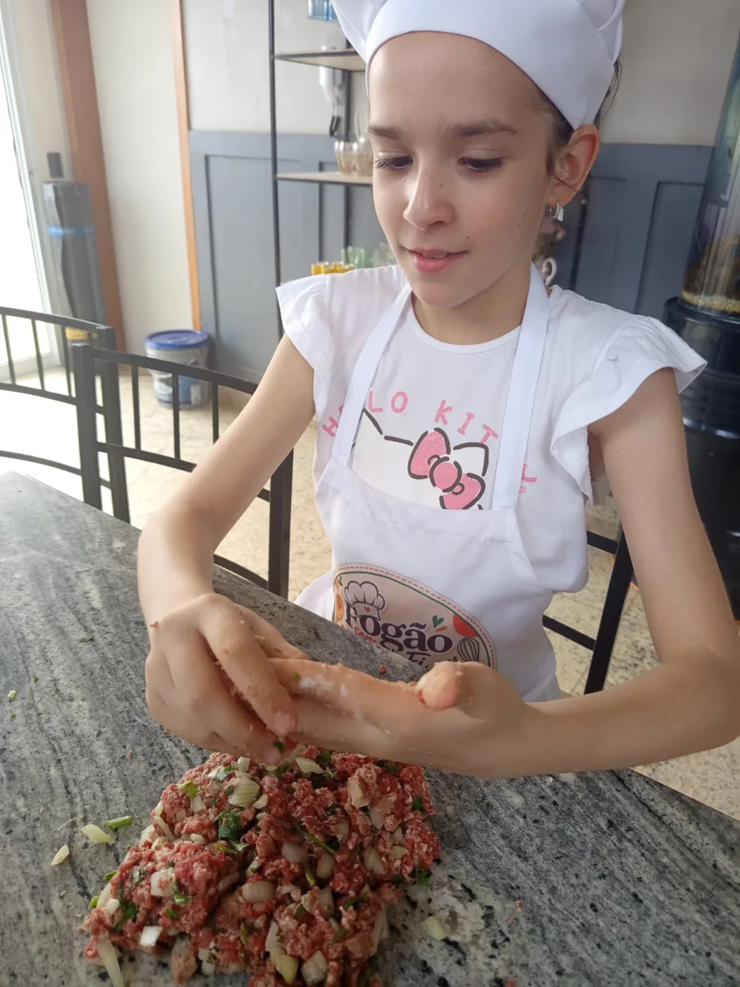 Aluna com touca e avental misturando os ingredientes da receita